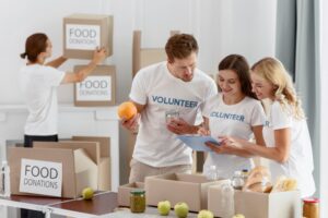 smiley-volunteers-preparing-food-charity